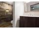 Updated bathroom featuring a stand up shower, wood-look tiling, and modern vanity at 1819 King Alfred Sw Dr, Atlanta, GA 30331