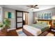 Comfortable bedroom features a queen size bed, ceiling fan, and a unique sliding door at 1819 King Alfred Sw Dr, Atlanta, GA 30331