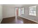 Bedroom with hardwood floors and two bright windows, creating a cozy and inviting atmosphere at 1819 King Alfred Sw Dr, Atlanta, GA 30331