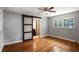 The main bedroom includes hardwood floors, a sliding door to bath, and a large window at 1819 King Alfred Sw Dr, Atlanta, GA 30331