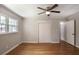 Neutral bedroom features hardwood floors, ceiling fan and natural light from the window at 1819 King Alfred Sw Dr, Atlanta, GA 30331