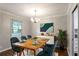 Dining room featuring a wooden table, comfortable seating, and a modern chandelier at 1819 King Alfred Sw Dr, Atlanta, GA 30331