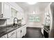 Bright kitchen featuring granite countertops, stainless steel appliances, and white cabinets at 1819 King Alfred Sw Dr, Atlanta, GA 30331