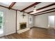 The open living room with wood floors includes fireplace and beamed ceilings at 1819 King Alfred Sw Dr, Atlanta, GA 30331