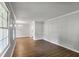 Open-concept living space with hardwood floors, connecting seamlessly to the dining area at 1819 King Alfred Sw Dr, Atlanta, GA 30331