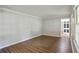 Spacious living area featuring hardwood floors and ample natural light from the large windows at 1819 King Alfred Sw Dr, Atlanta, GA 30331