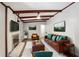 Spacious living room featuring wood beams, fireplace and comfortable leather furniture at 1819 King Alfred Sw Dr, Atlanta, GA 30331