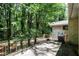 Back patio with a grill, brick exterior, and a wooded view at 1819 King Alfred Sw Dr, Atlanta, GA 30331