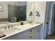 Elegant bathroom featuring a double vanity, luxurious countertops, and a frameless glass shower at 2893 Elmwood Dr, Smyrna, GA 30080