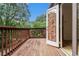 Wooden balcony featuring a view of the surrounding trees and greenery at 323 8Th Ne St # 7, Atlanta, GA 30309