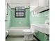 Retro bathroom featuring a tub, toilet, and sink with classic green and black tile at 323 8Th Ne St # 7, Atlanta, GA 30309