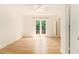 Bedroom with neutral walls, hardwood floors, access to a private balcony, and adjoining rooms at 323 8Th Ne St # 7, Atlanta, GA 30309