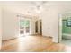 Bedroom with neutral walls, hardwood floors, ceiling fan, balcony access, and closet storage at 323 8Th Ne St # 7, Atlanta, GA 30309