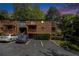 Exterior view of brick condo building featuring balconies and parking at 323 8Th Ne St # 7, Atlanta, GA 30309