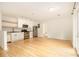Open kitchen with stainless steel appliances, white cabinets, and light hardwood flooring at 323 8Th Ne St # 7, Atlanta, GA 30309