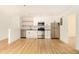 Bright kitchen with stainless steel appliances, white cabinets and backsplash, and hardwood floors at 323 8Th Ne St # 7, Atlanta, GA 30309