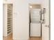 A cozy laundry room with a stacked washer and dryer and shelving unit at 323 8Th Ne St # 7, Atlanta, GA 30309