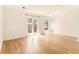 Bright, airy living room features gleaming hardwood floors and sliding glass doors to balcony at 323 8Th Ne St # 7, Atlanta, GA 30309