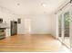 Open-concept living area with hardwood floors, stainless steel appliances, and balcony access at 323 8Th Ne St # 7, Atlanta, GA 30309