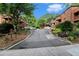 Street view of a brick condo complex with wooded scenery at 323 8Th Ne St # 7, Atlanta, GA 30309