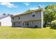 A green backyard shows a two-story house on a sunny day at 4065 Waters End Ln, Snellville, GA 30039