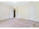 A carpeted bedroom contains two doors and a closet for ample storage space at 4065 Waters End Ln, Snellville, GA 30039