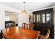 Formal dining room with a wooden table, decorative chandelier, and a view into the living room and kitchen at 4065 Waters End Ln, Snellville, GA 30039