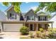 Charming two-story home featuring gray siding, black shutters, brick accents, and a well-maintained front yard at 4065 Waters End Ln, Snellville, GA 30039