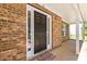 Covered porch with a brick facade leading to a black front door with sidelights and a 'welcome friends' mat at 4065 Waters End Ln, Snellville, GA 30039