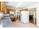 Eat-in kitchen featuring granite countertops, stainless steel appliances, and natural wood cabinets at 4065 Waters End Ln, Snellville, GA 30039