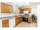 Traditional eat-in kitchen with natural wood cabinets, and stainless steel oven and microwave at 4065 Waters End Ln, Snellville, GA 30039