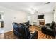 Inviting living room featuring hardwood floors, a fireplace, and comfortable black leather seating at 4065 Waters End Ln, Snellville, GA 30039