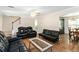 Open-concept living area with hardwood floors, comfortable black furniture, and easy access to the dining area at 4065 Waters End Ln, Snellville, GA 30039