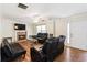 Spacious living room with a fireplace, hardwood floors, and comfortable black leather seating arrangement at 4065 Waters End Ln, Snellville, GA 30039