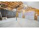 An unfinished basement featuring framed walls and two insulated garage doors at 5590 Princeton Oaks Dr, Sugar Hill, GA 30518