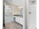 Modern bathroom with a large shower, granite countertop vanity, and wood-style flooring at 5590 Princeton Oaks Dr, Sugar Hill, GA 30518