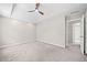Large bedroom with carpeted floor, ceiling fan, and neutral paint at 5590 Princeton Oaks Dr, Sugar Hill, GA 30518