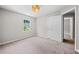 Bedroom with neutral walls, carpet, and a view to the backyard at 5590 Princeton Oaks Dr, Sugar Hill, GA 30518