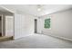Neutral bedroom with doors leading to a closet, the hallway, and a window view at 5590 Princeton Oaks Dr, Sugar Hill, GA 30518