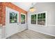 Bright dining area with exposed brick, large windows with backyard view, and elegant trim at 5590 Princeton Oaks Dr, Sugar Hill, GA 30518