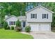 Charming home with a two-car garage, beautiful landscaping and a welcoming entrance at 5590 Princeton Oaks Dr, Sugar Hill, GA 30518