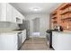 Well-equipped kitchen boasting stainless steel appliances, ample countertop space, and brick wall with shelves at 5590 Princeton Oaks Dr, Sugar Hill, GA 30518