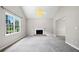 Open living room with lots of natural light, neutral paint, and cozy fireplace at 5590 Princeton Oaks Dr, Sugar Hill, GA 30518