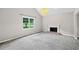 Bright living room featuring fireplace and large window for natural light at 5590 Princeton Oaks Dr, Sugar Hill, GA 30518