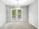 Inviting room with French doors opening to a deck and offering ample natural light at 5590 Princeton Oaks Dr, Sugar Hill, GA 30518