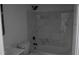 Renovated bathroom featuring marble-like tile on the wall around the bathtub at 6460 Wellington Chase Ct, Lithonia, GA 30058