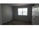 Gray bedroom featuring a window, grey carpet, and a closet with a white door at 6460 Wellington Chase Ct, Lithonia, GA 30058