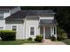 Traditional two-story townhouse with beige siding, dark roof and landscaped front yard at 6460 Wellington Chase Ct, Lithonia, GA 30058