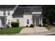 Charming townhome with manicured lawn, front porch, and convenient parking spaces at 6460 Wellington Chase Ct, Lithonia, GA 30058