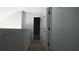 Hallway featuring gray walls, carpet, and white doors leading to other rooms at 6460 Wellington Chase Ct, Lithonia, GA 30058